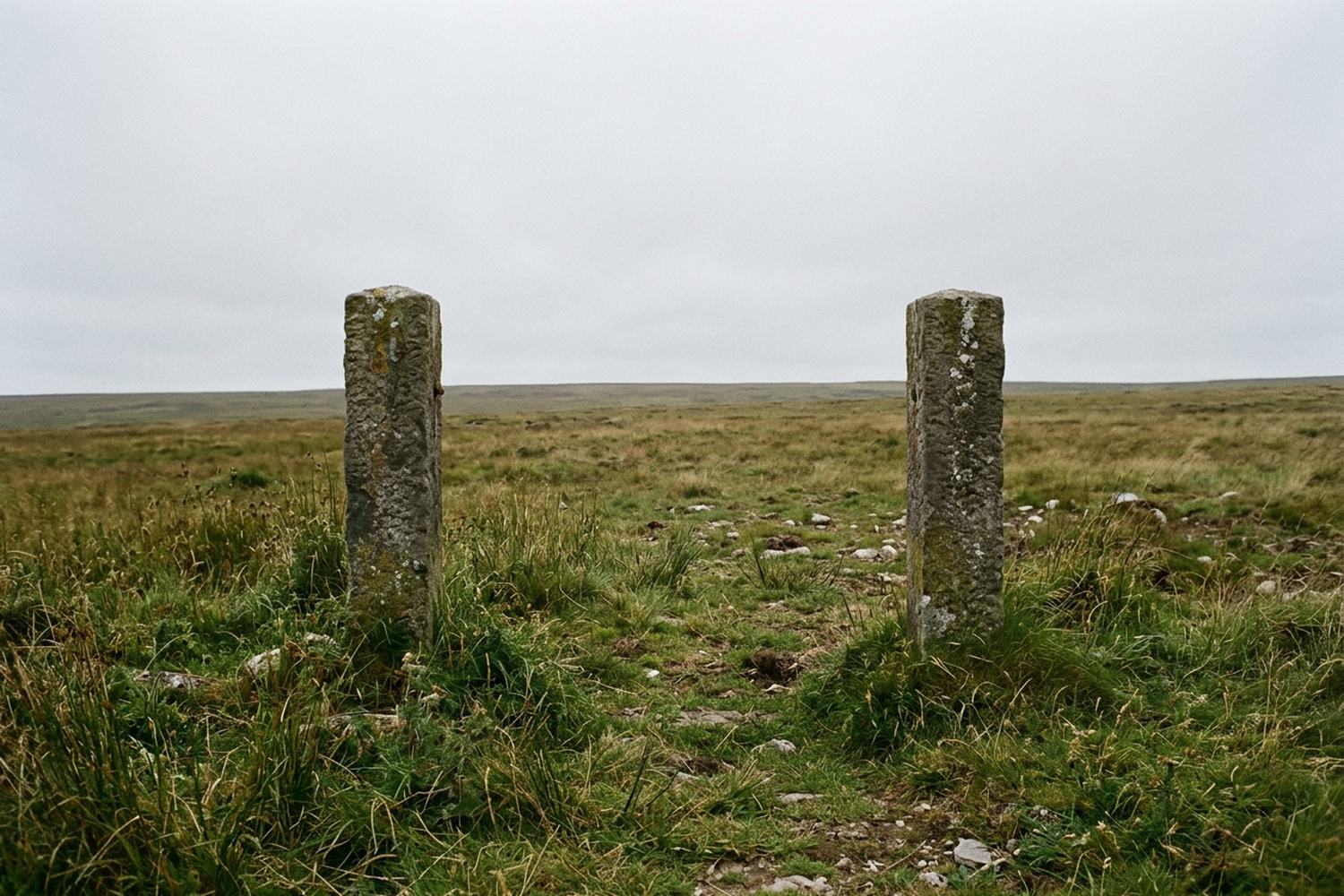 Two square stone gateposts with nothing between them.