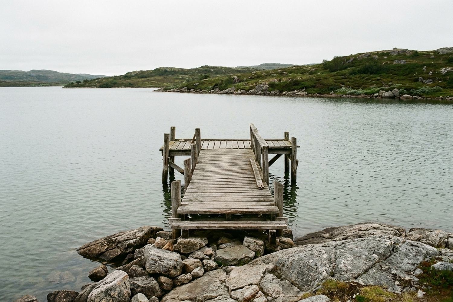 A small wooden landing stage on a still northern lake.