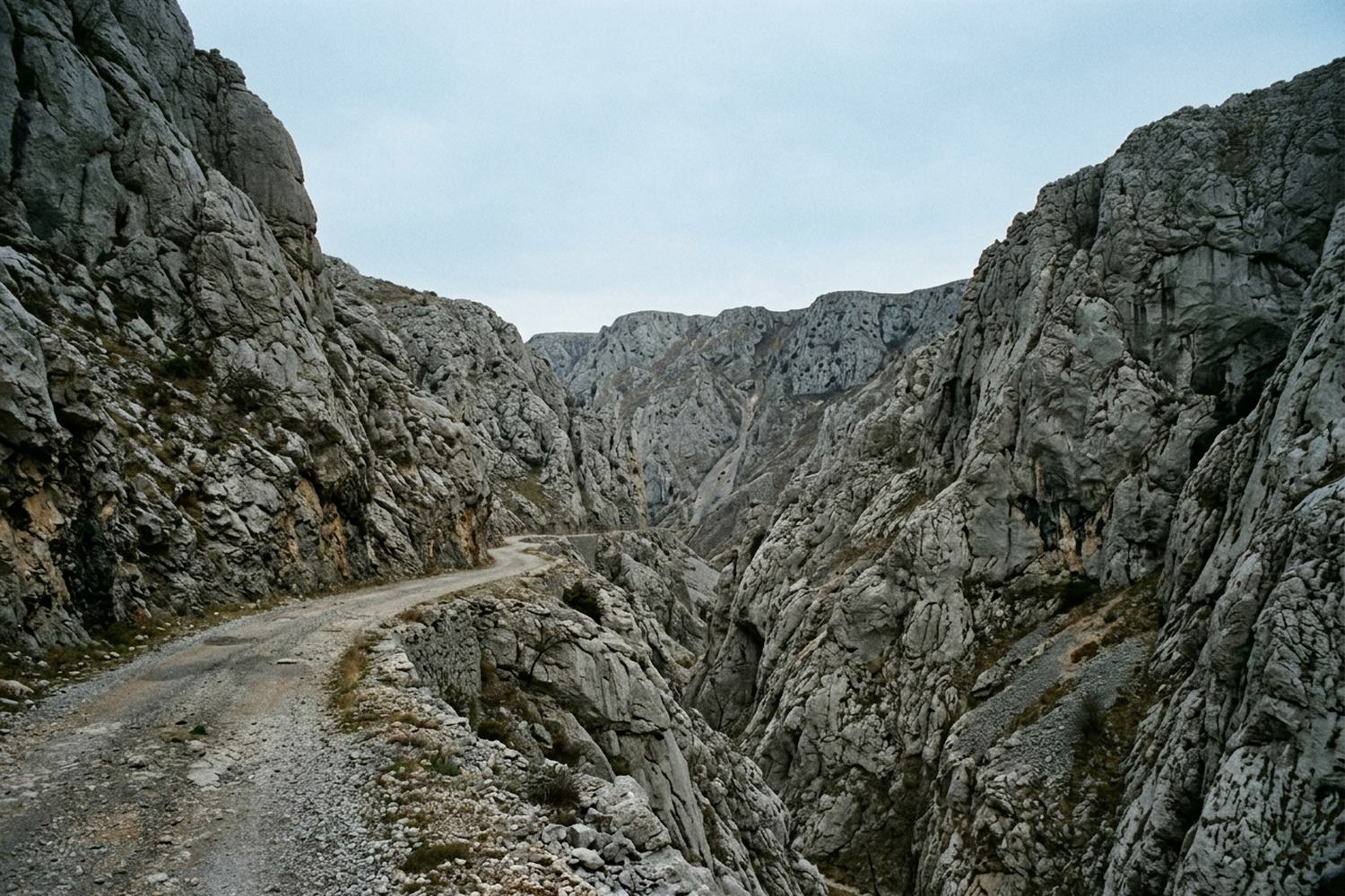 A limestone gorge with a road cut along one wall.